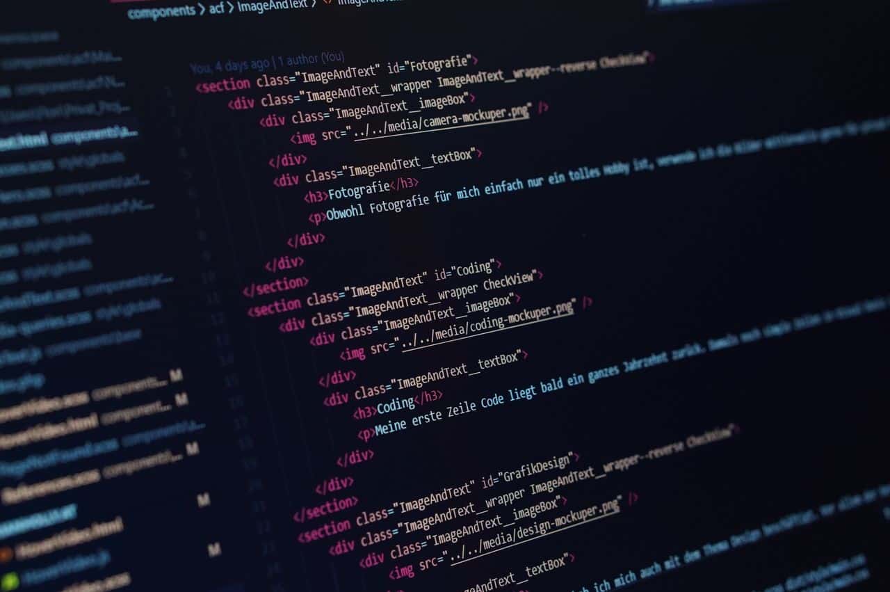 Close-up view of HTML code displayed on a dark screen, showcasing coding concepts.